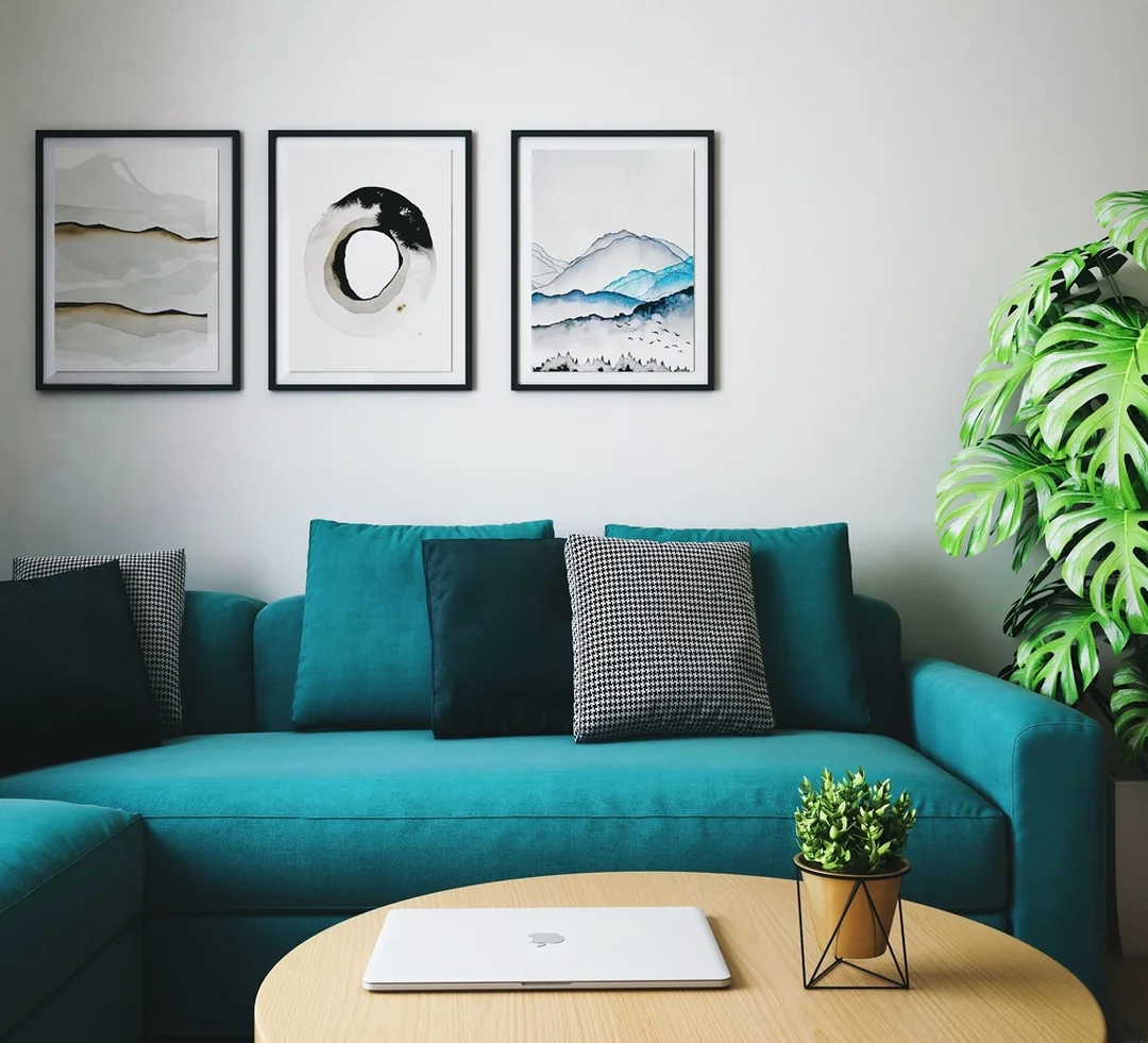 khung tranh nice house trong phòng khách sofa xanh